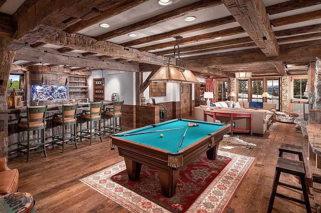 rustic game room with a pool table and home bar