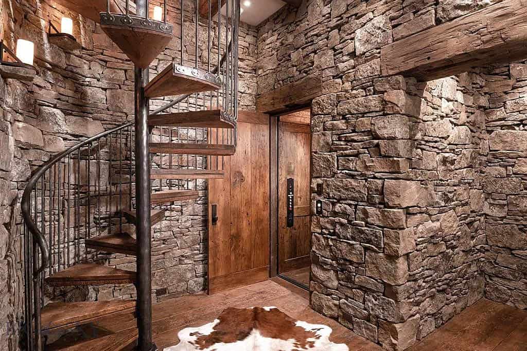 rustic hallway with a spiral staircase and elevator