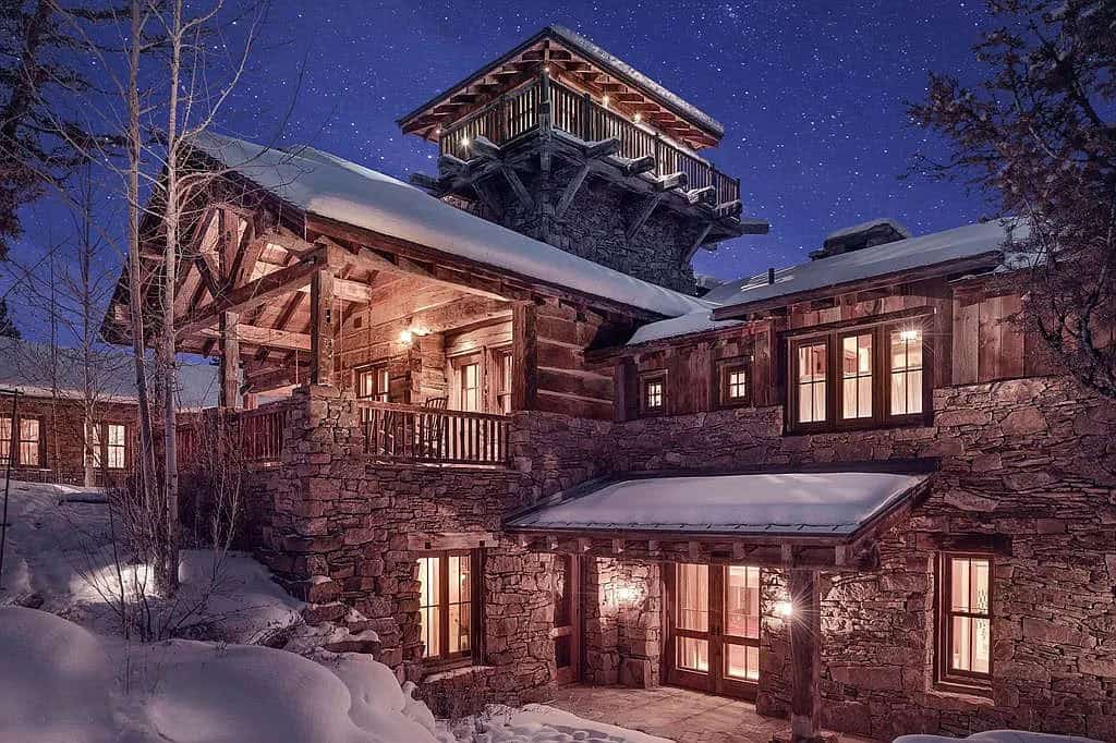 mountain home exterior with snow at dusk