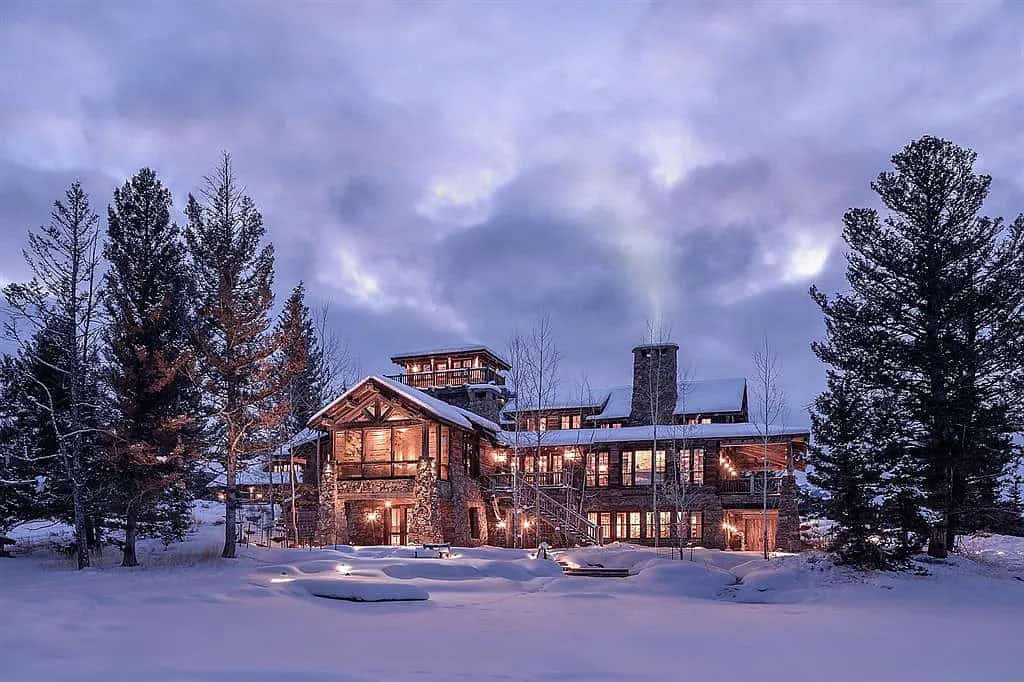 mountain home exterior with snow at dusk