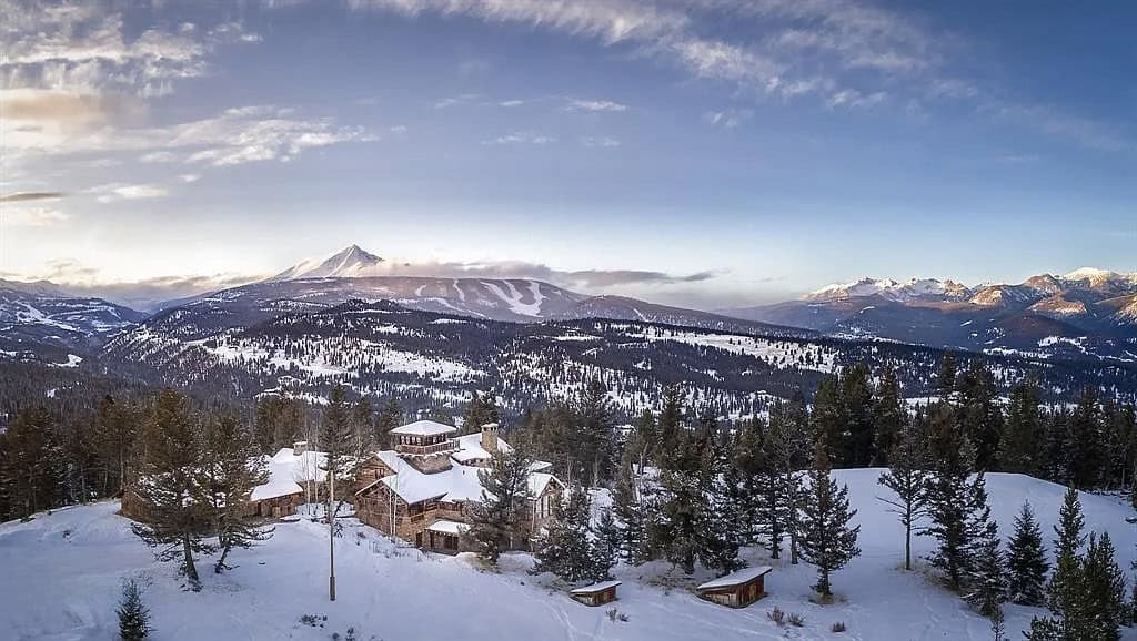 mountain home exterior with snow aerial view