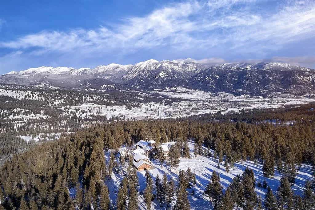mountain home exterior with snow aerial view