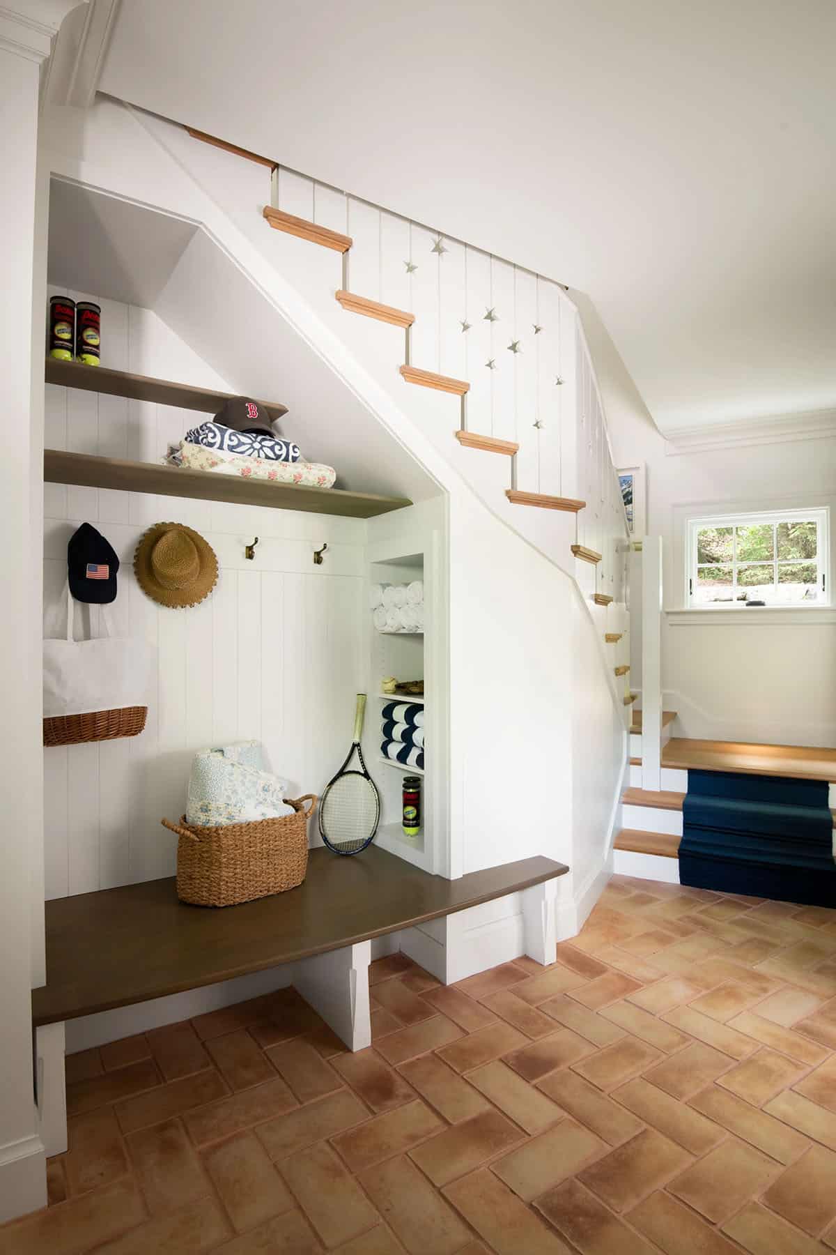 contemporary mudroom with a built-in bench and staircase