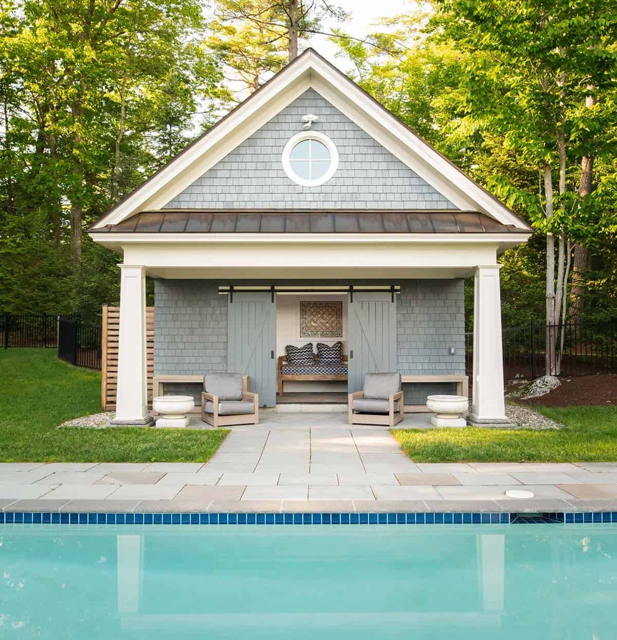 shingle style lake house swimming pool with a pool house