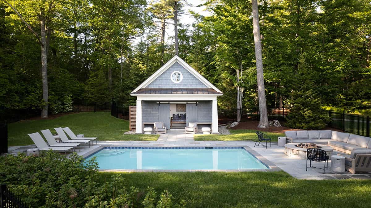 shingle style lake house swimming pool with a pool house