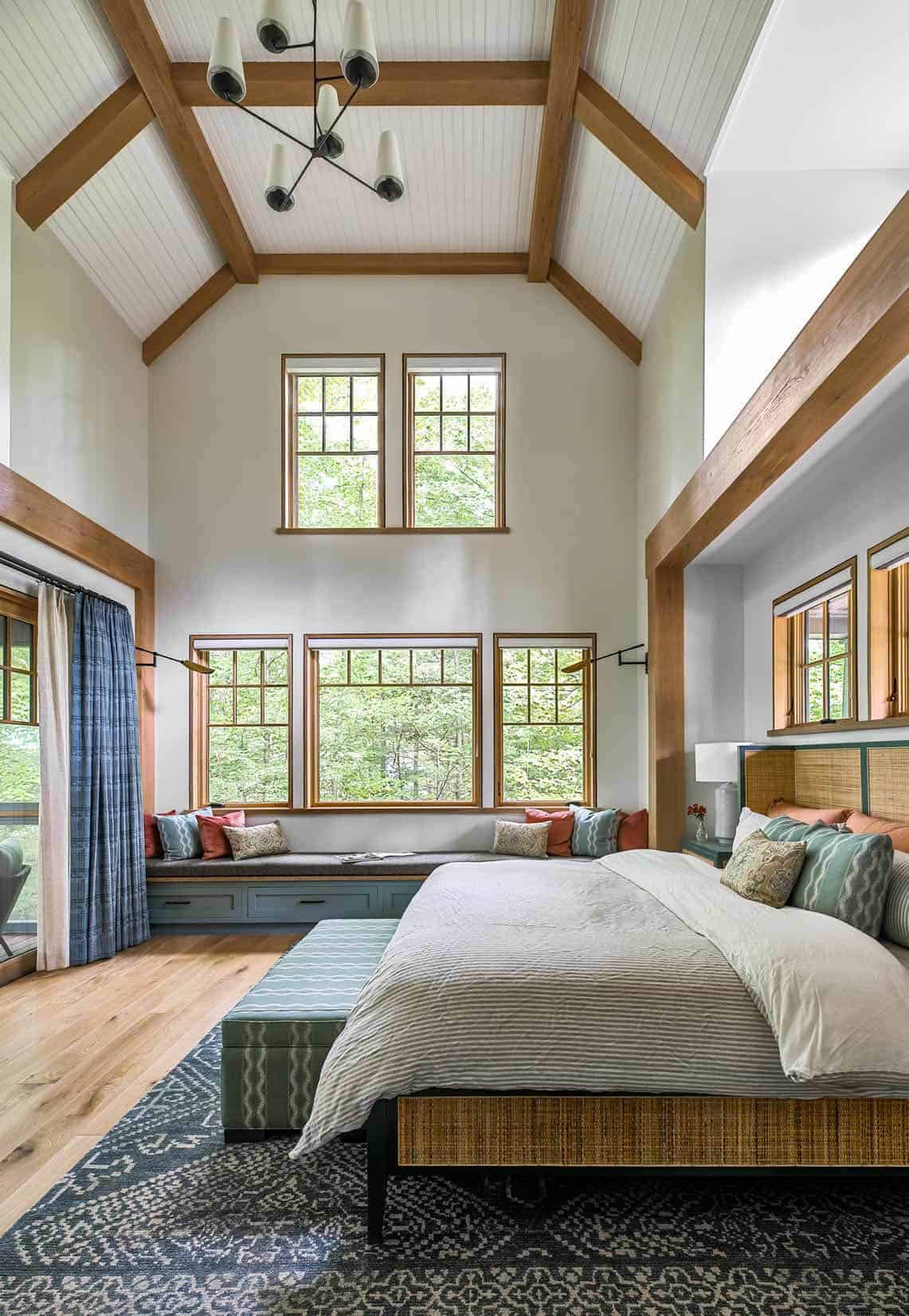 contemporary bedroom with a built-in window seat and tall ceilings