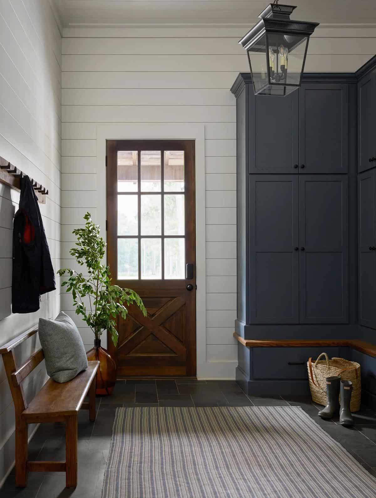 rustic modern mudroom entry with a bench