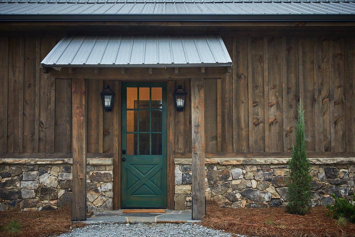 rustic modern barn house exterior with a green door