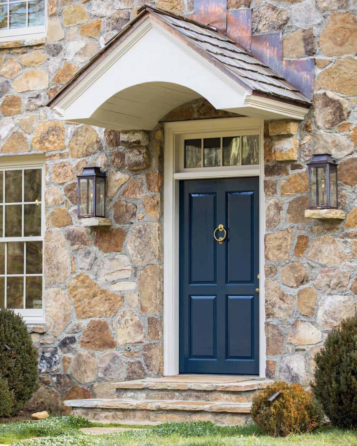 stone farmhouse exterior entry with a blue door