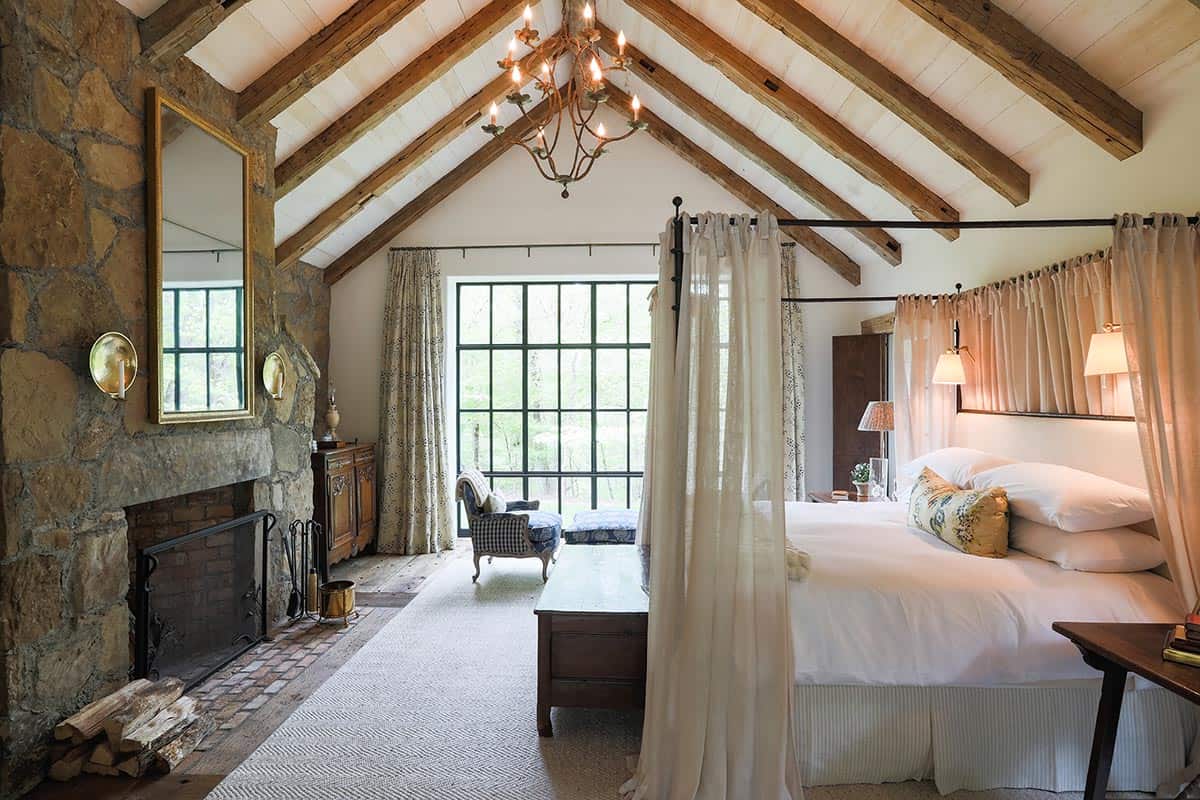 farmhouse style bedroom with a fireplace