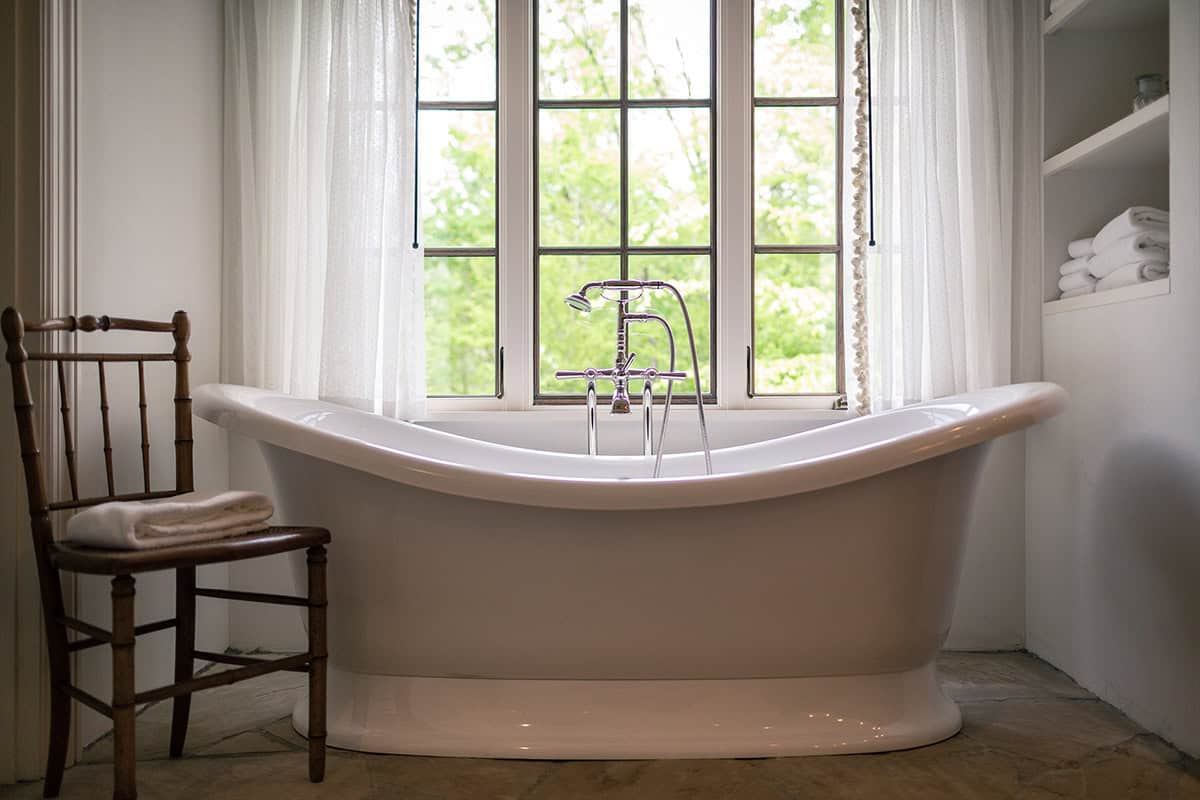 farmhouse style bathroom with a freestanding tub
