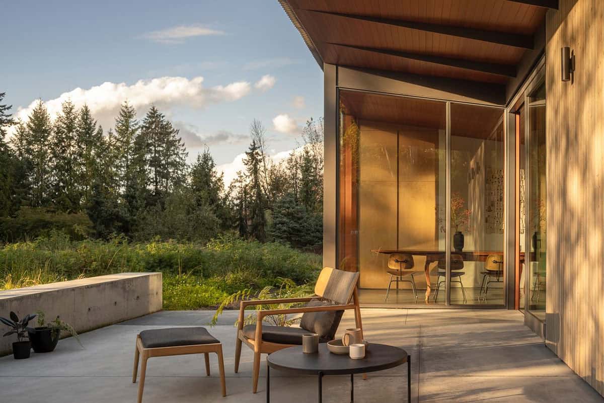 modern home exterior with a patio and lounge chairs