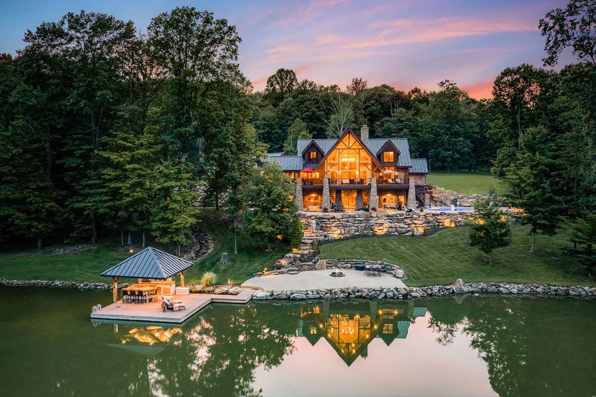 timber frame house exterior with a pond