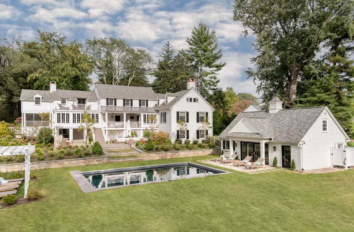 transitional style home exterior with a pool