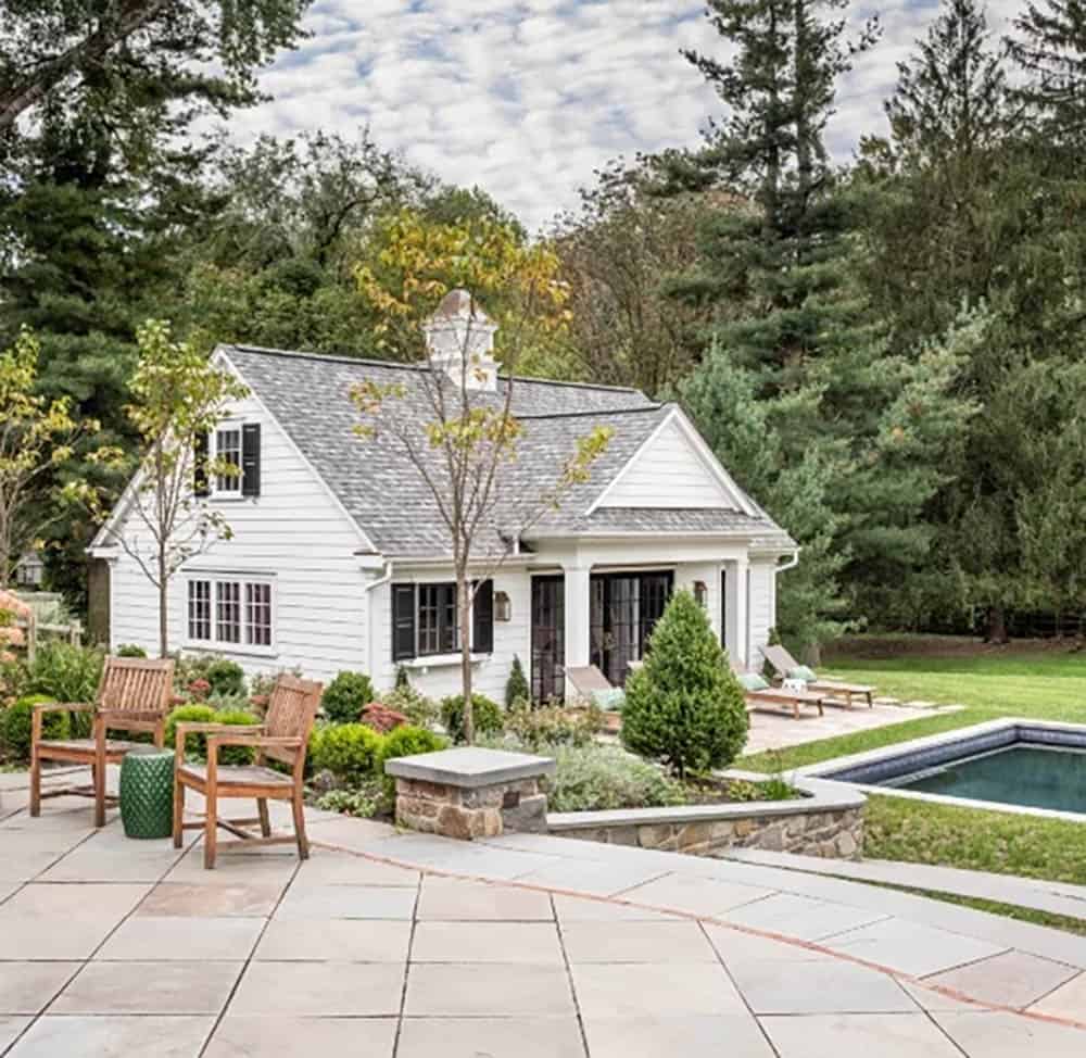 transitional style home exterior with a pool