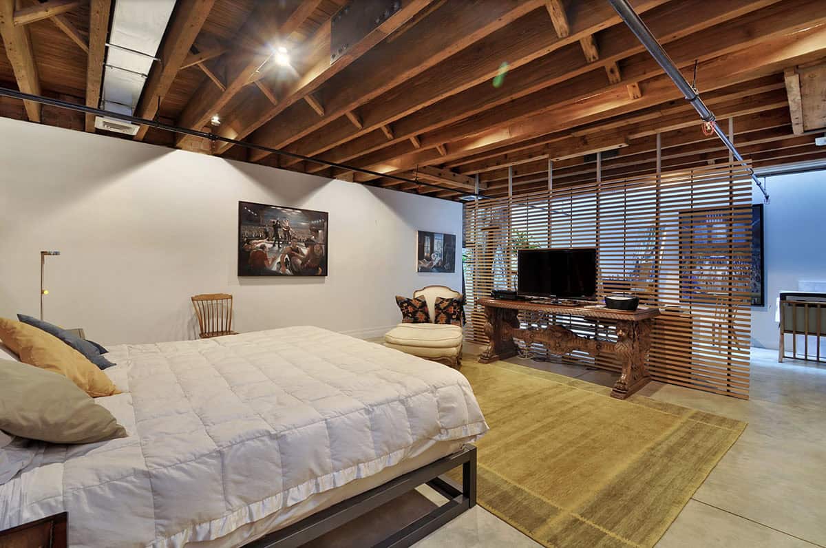 Industrial Bedroom in the basement with concrete floors