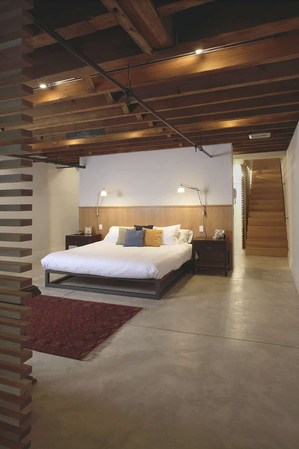 Industrial Bedroom in the basement with concrete floors