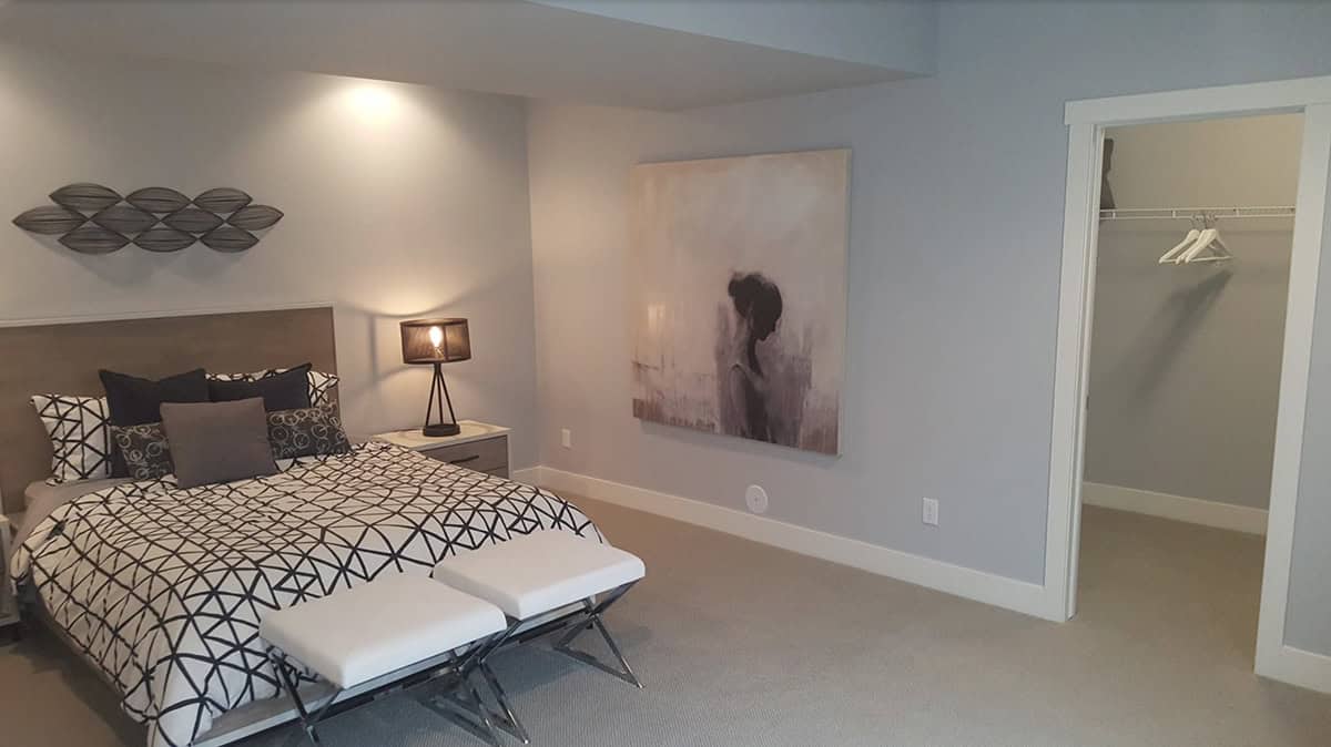 contemporary basement guest bedroom with gray walls