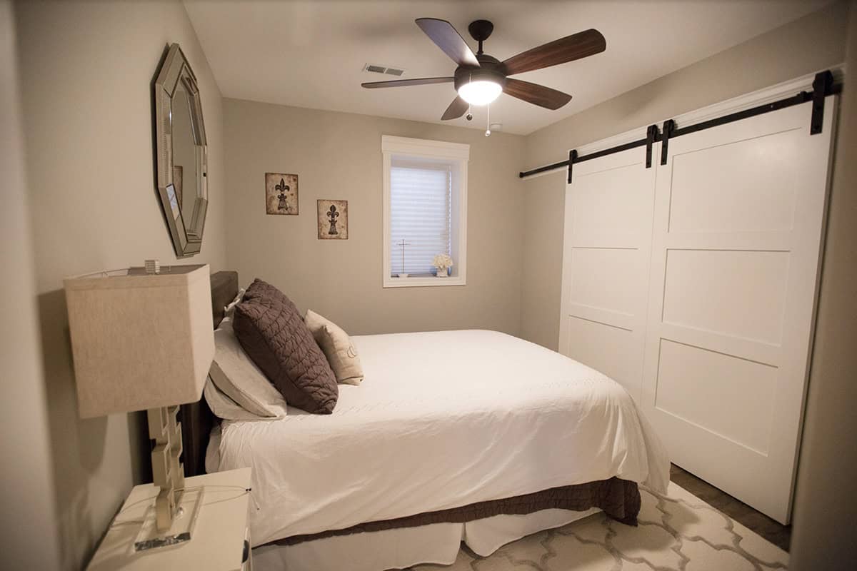 Transitional Basement Guest Bedroom with sliding barn closet doors