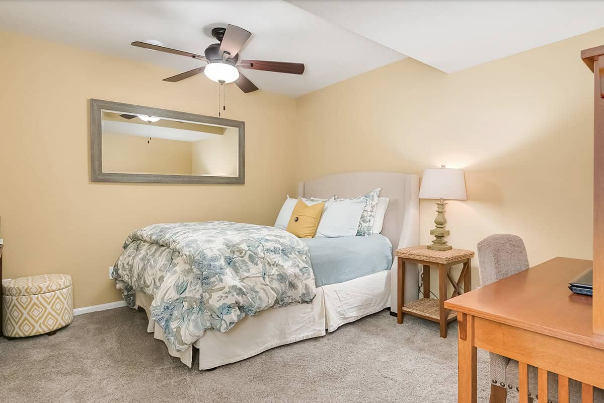 Transitional Basement guest bedroom with a work desk