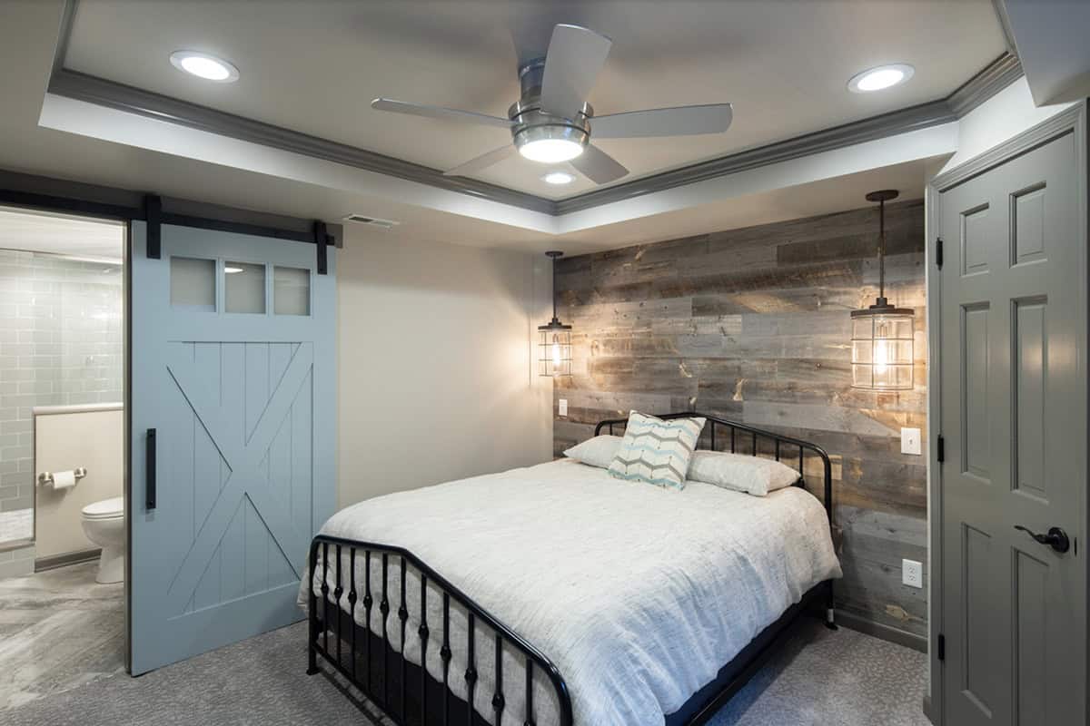 Transitional style basement guest bedroom with an en-suite bathroom
