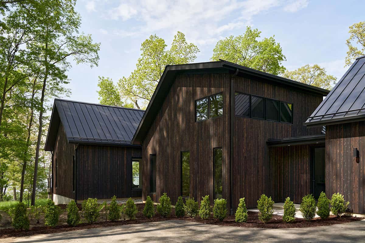 lake house exterior with dark shou sugi ban siding