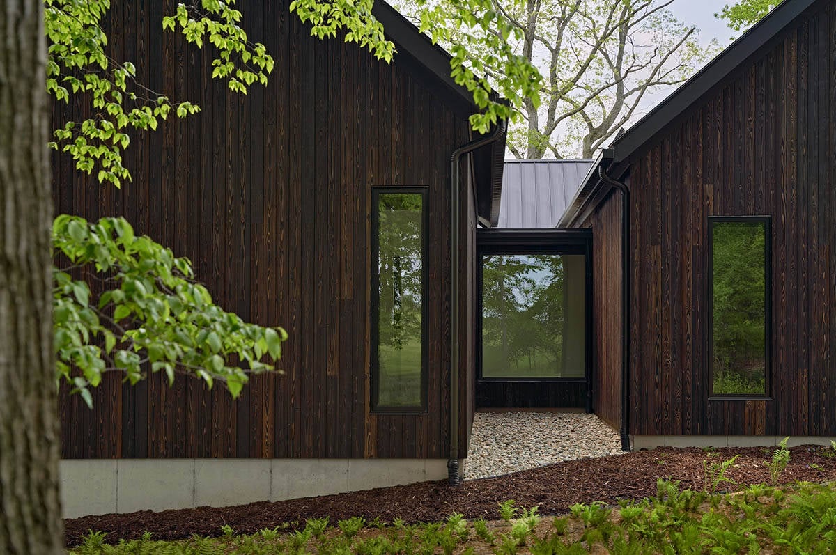 lake house exterior with dark shou sugi ban siding