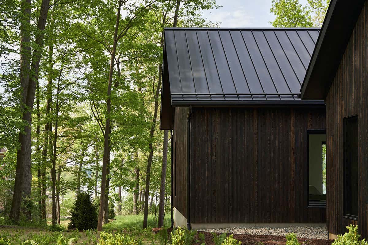 lake house exterior with dark shou sugi ban siding