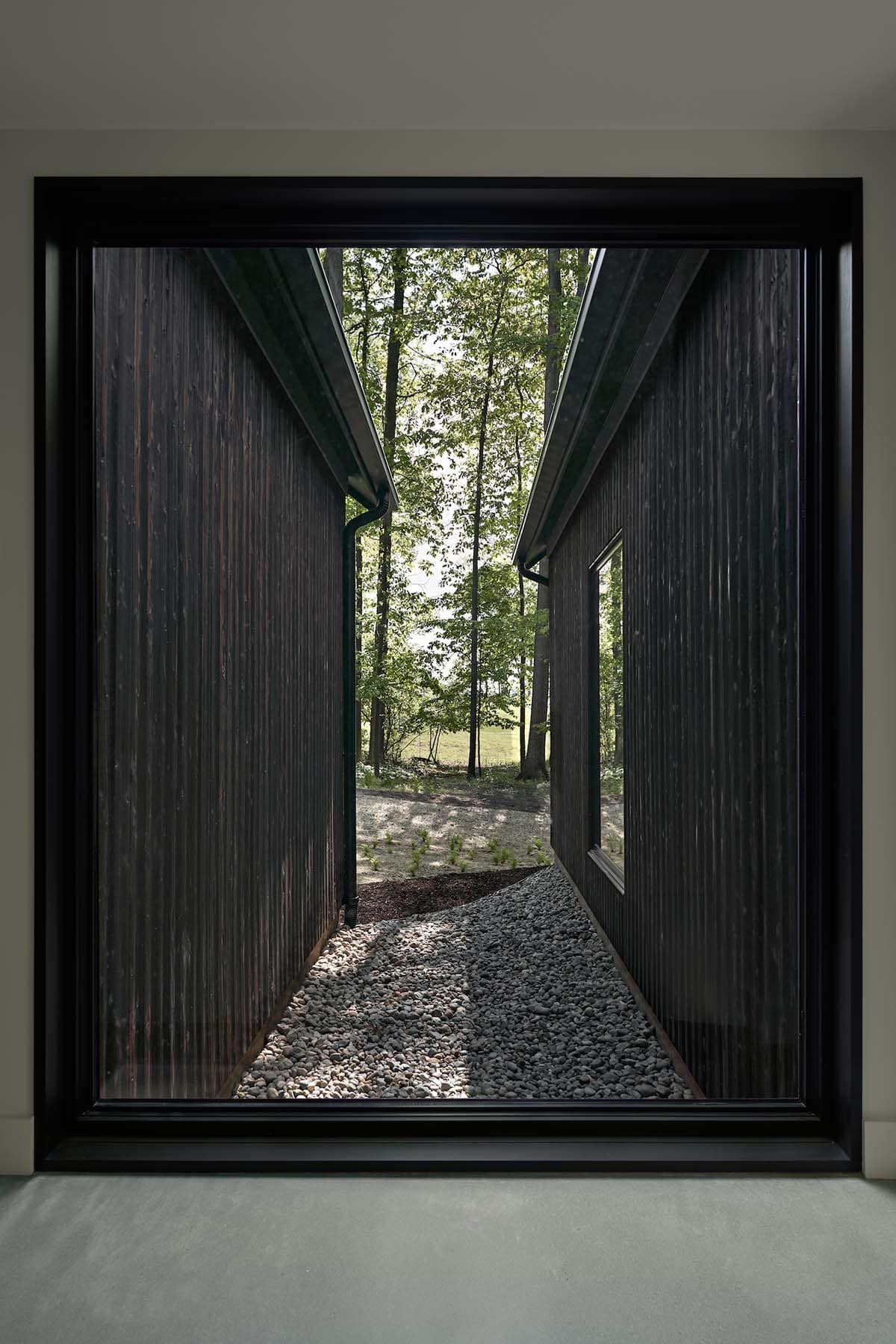 lake house exterior with dark shou sugi ban siding