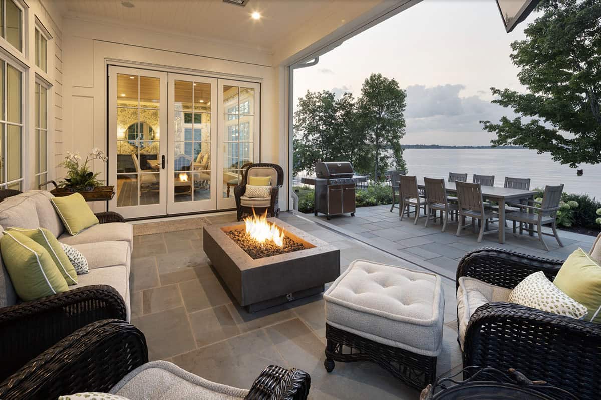 Beach Style Covered Patio with a fire pit