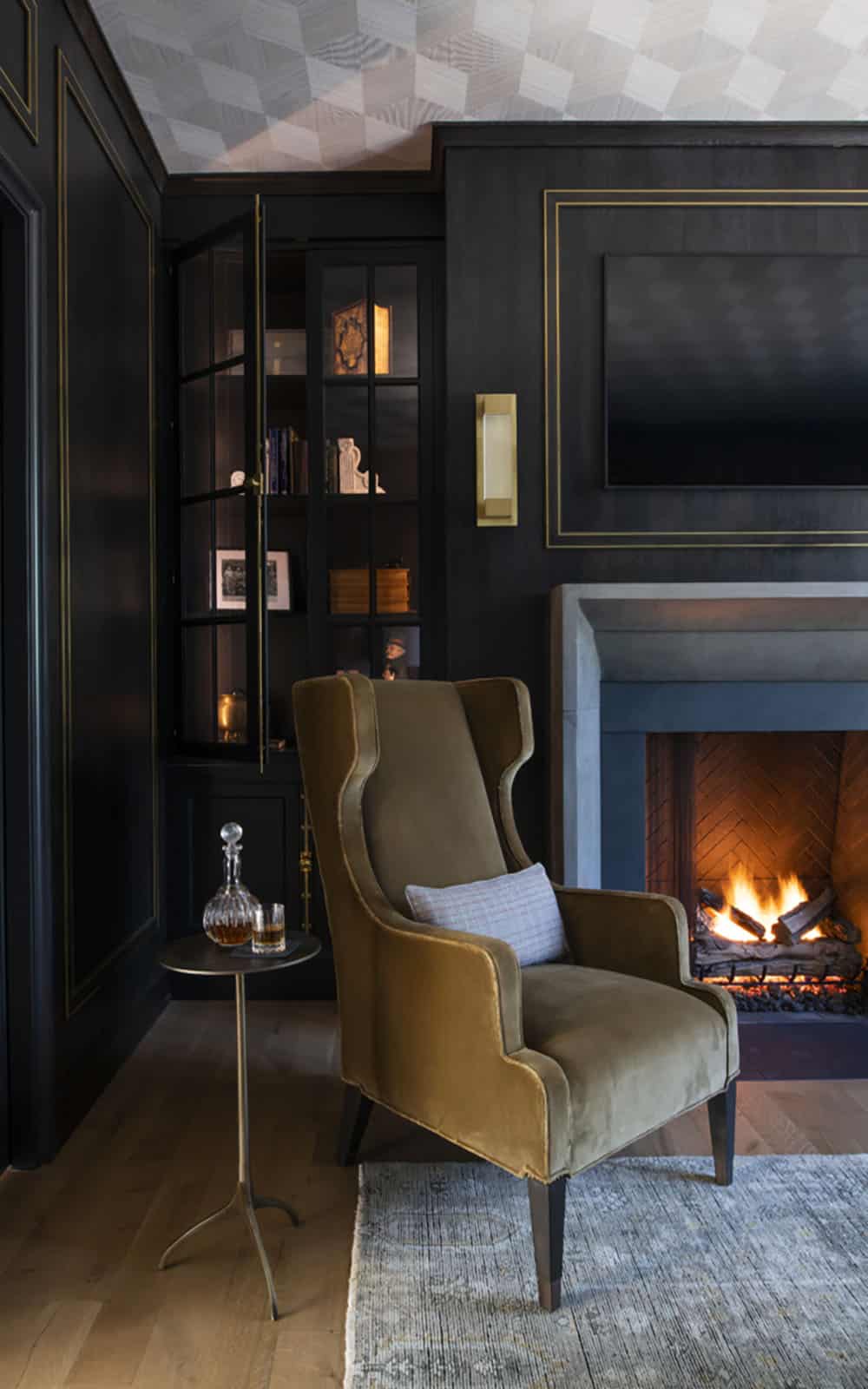 transitional style home library with a fireplace