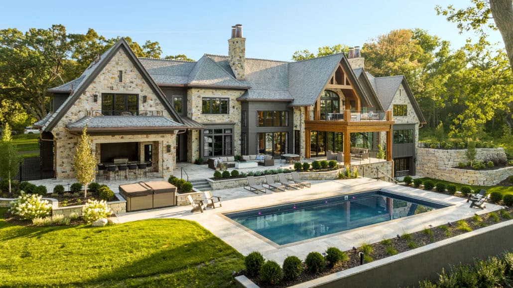 transitional style dream house exterior with a pool