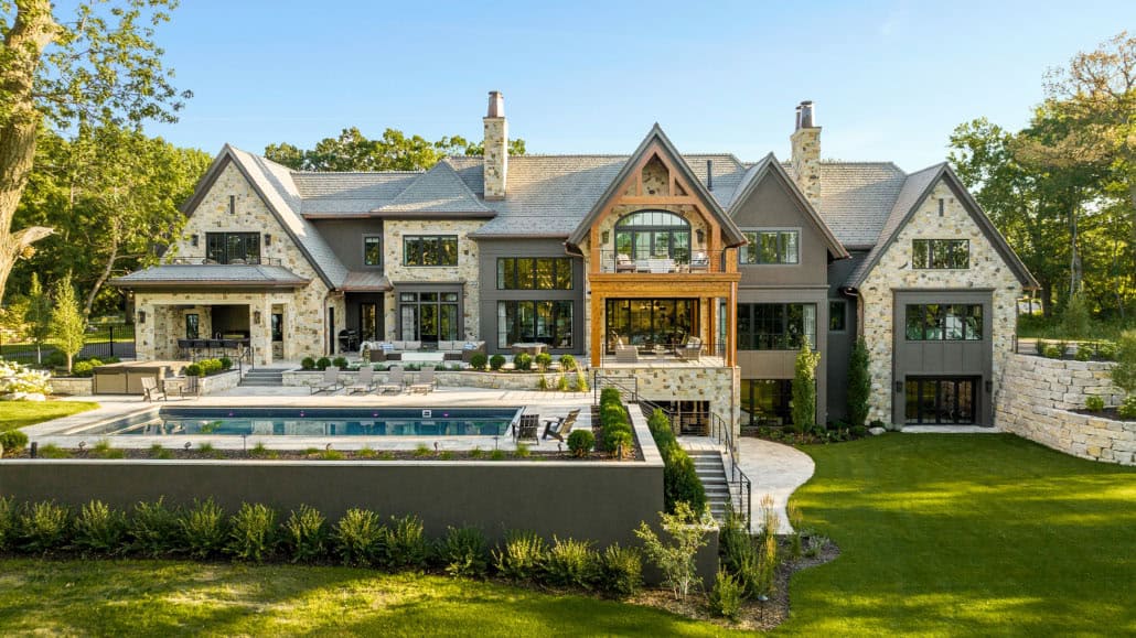 transitional style dream house exterior with a pool