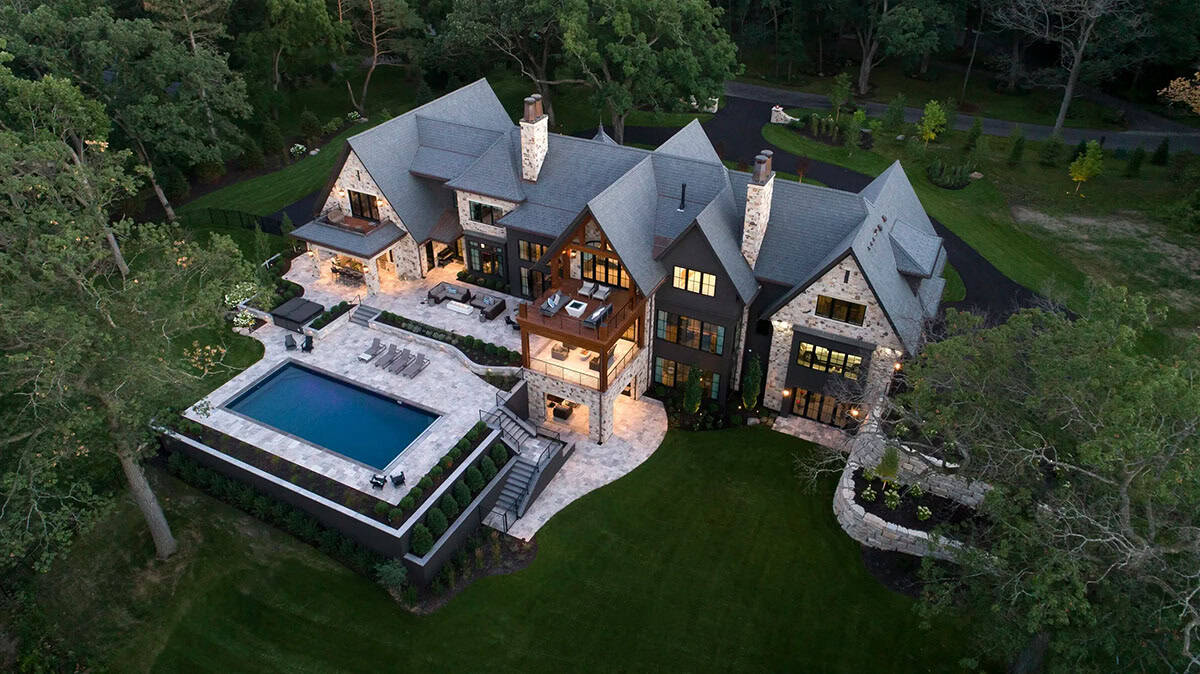 transitional style dream house exterior with a pool arial view