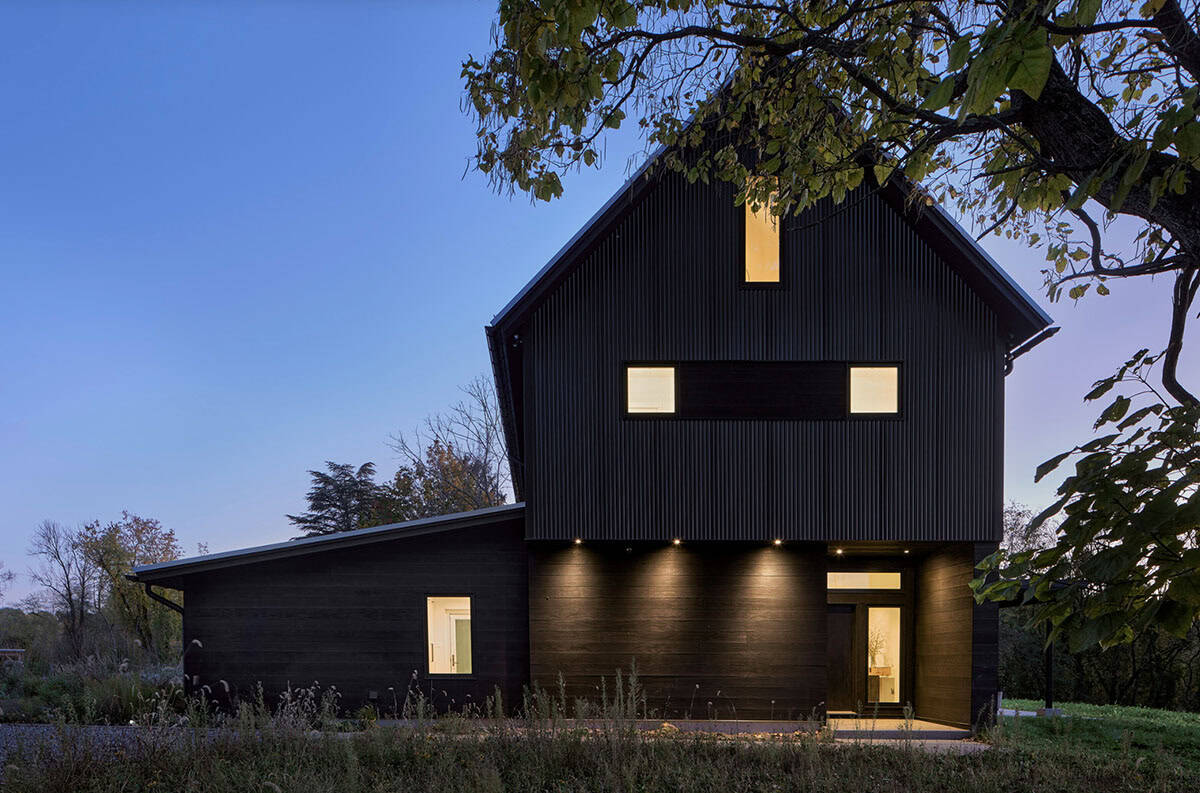 charred barn house exterior at dusk
