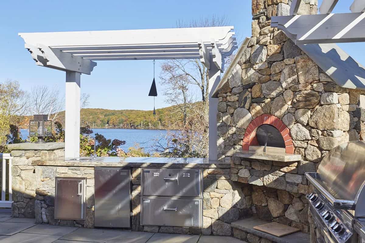 outdoor kitchen complete with wood fired pizza oven and built-in gas grill