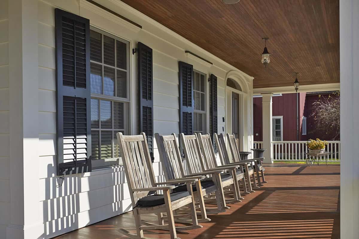 farmhouse covered front porch with rocking chairs