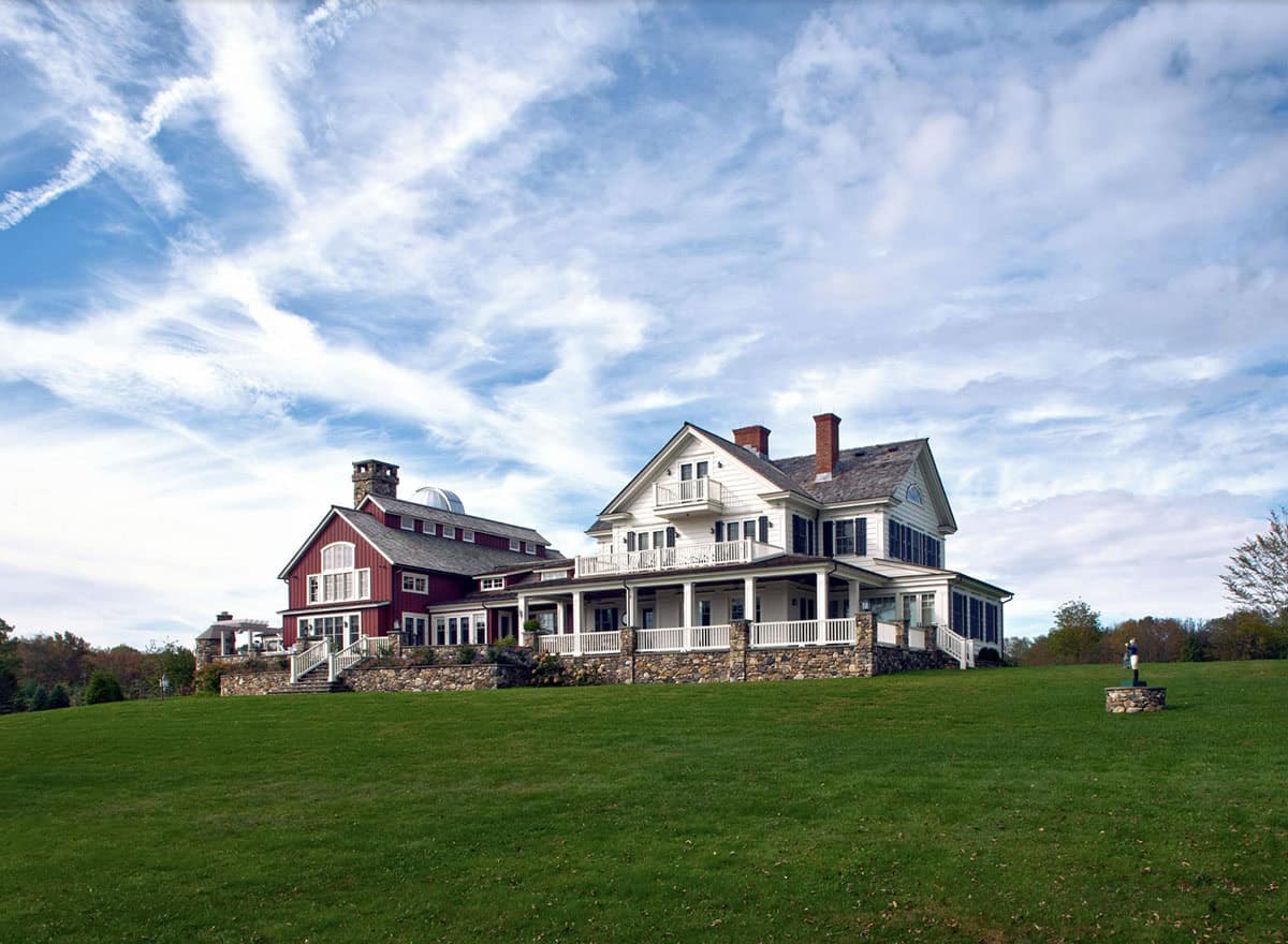 farm house with wrap around porch and barn