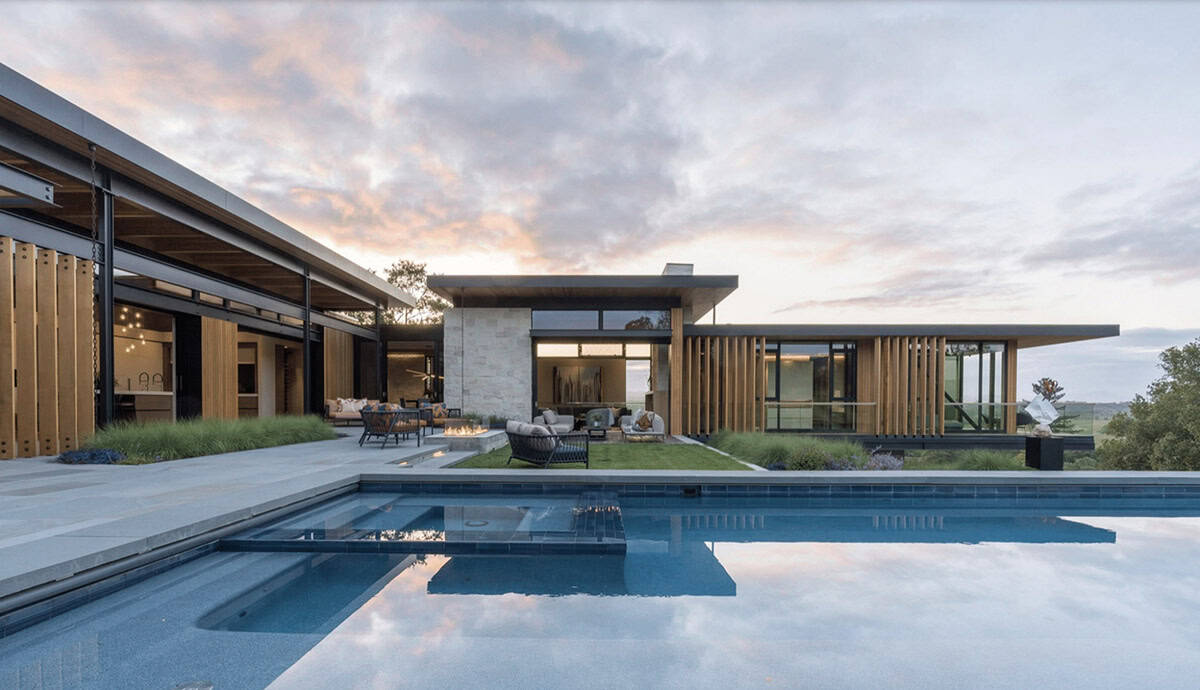 contemporary hillside home exterior with a pool