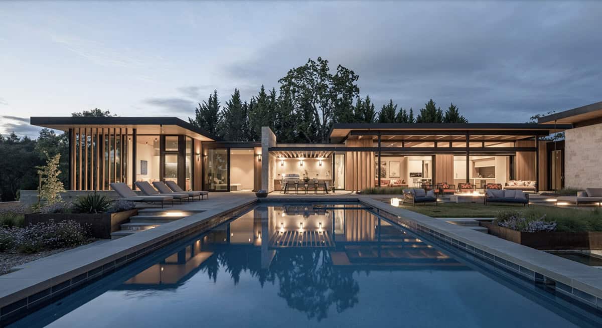 contemporary hillside home exterior with a pool