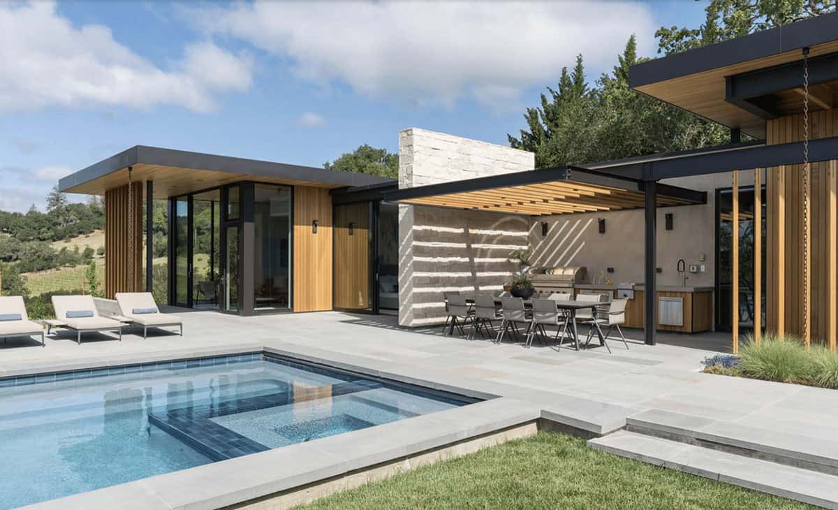 contemporary hillside home exterior with a pool