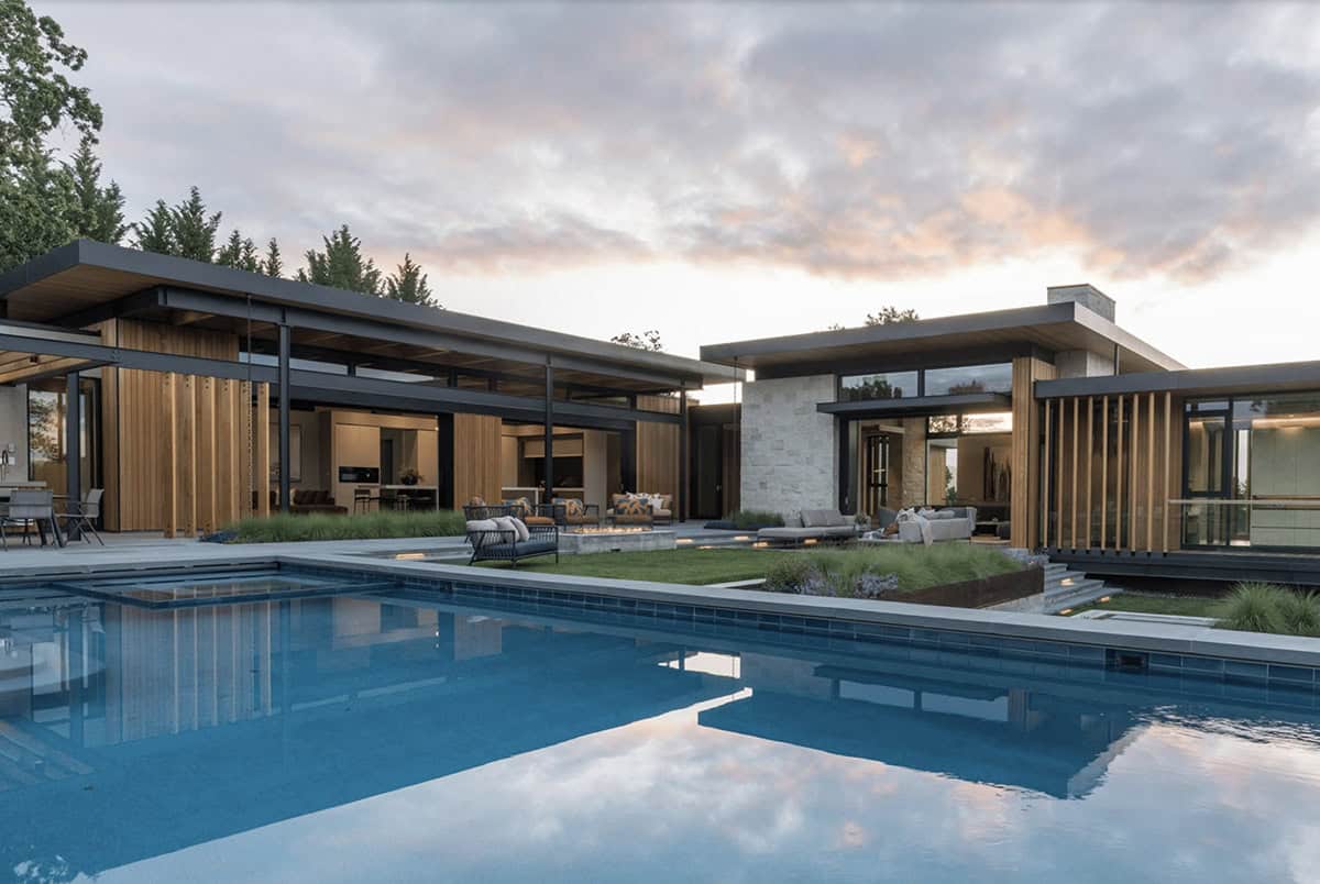 contemporary hillside home exterior with a pool