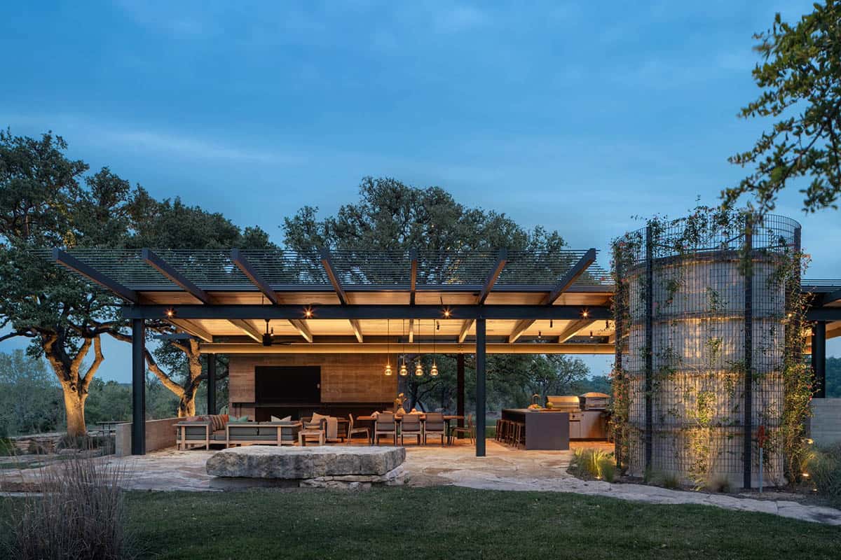 contemporary home exterior patio with a trellis at dusk