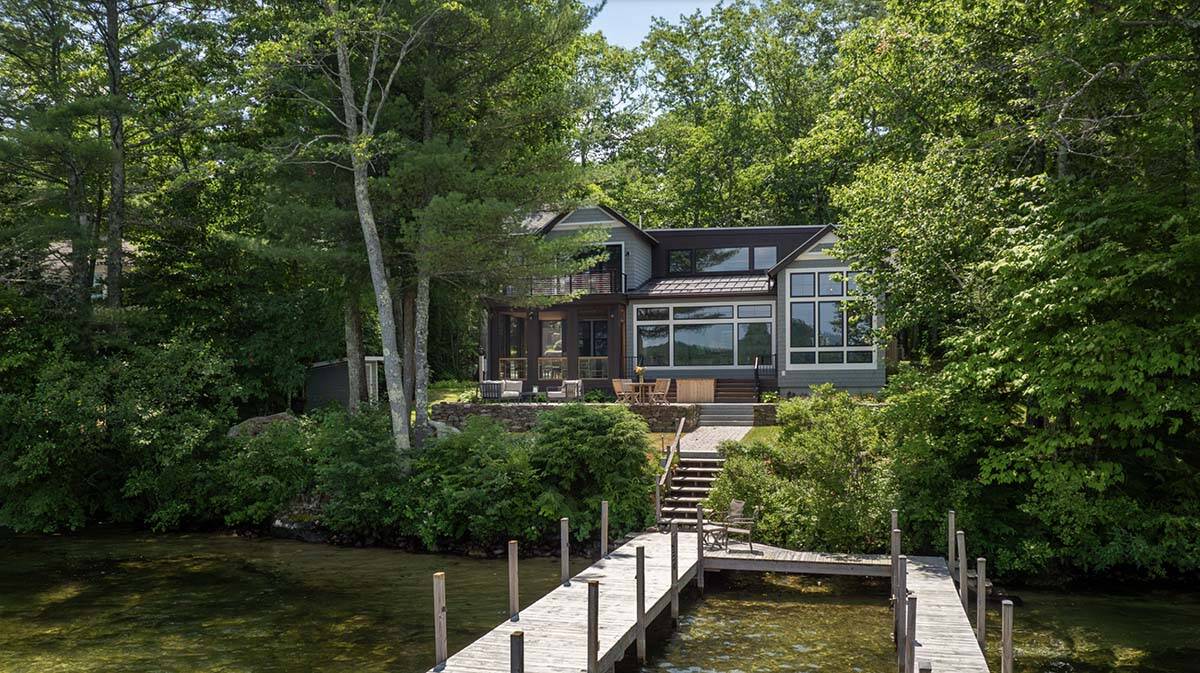 Contemporary Lake House Exterior Backyard with a deck over the water