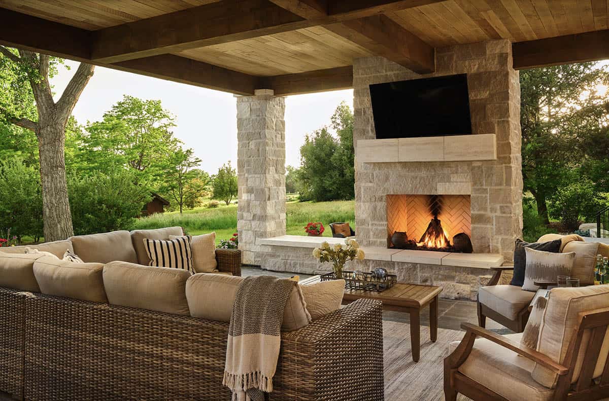 French Country Covered Patio with a fireplace