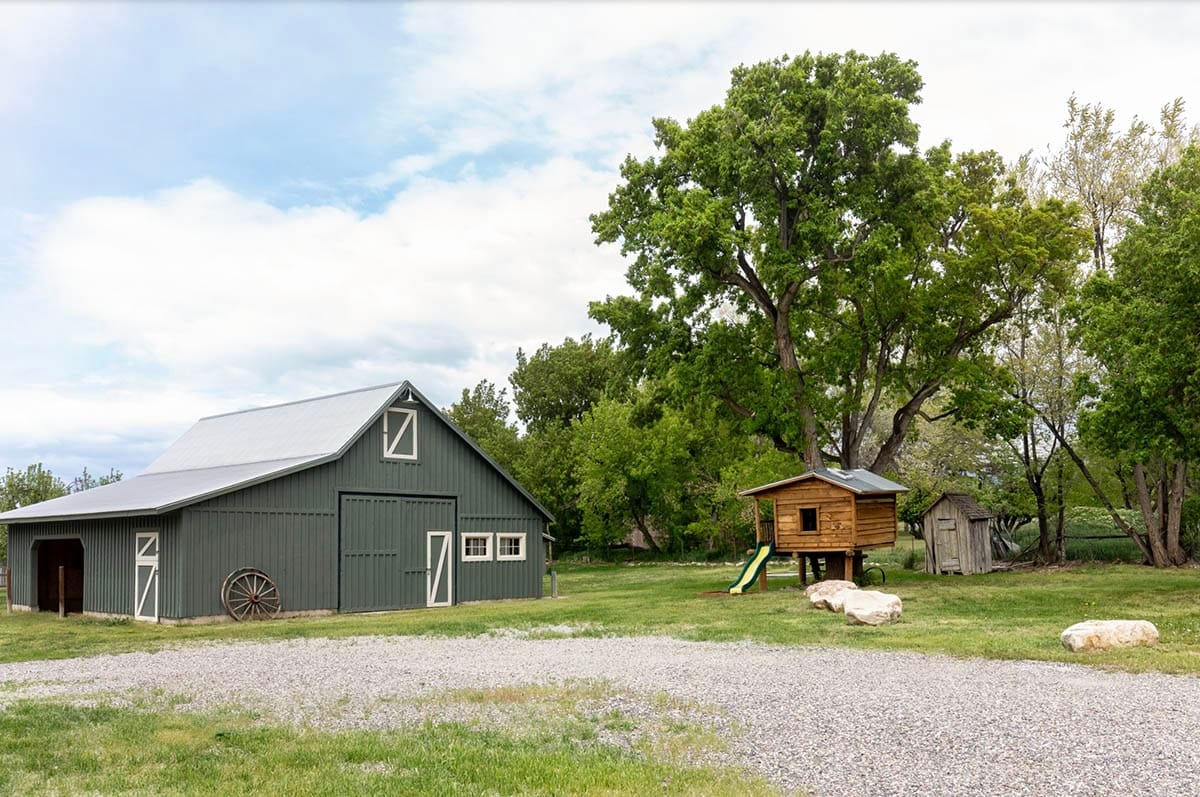 farmhouse style home exterior landscape with a barn