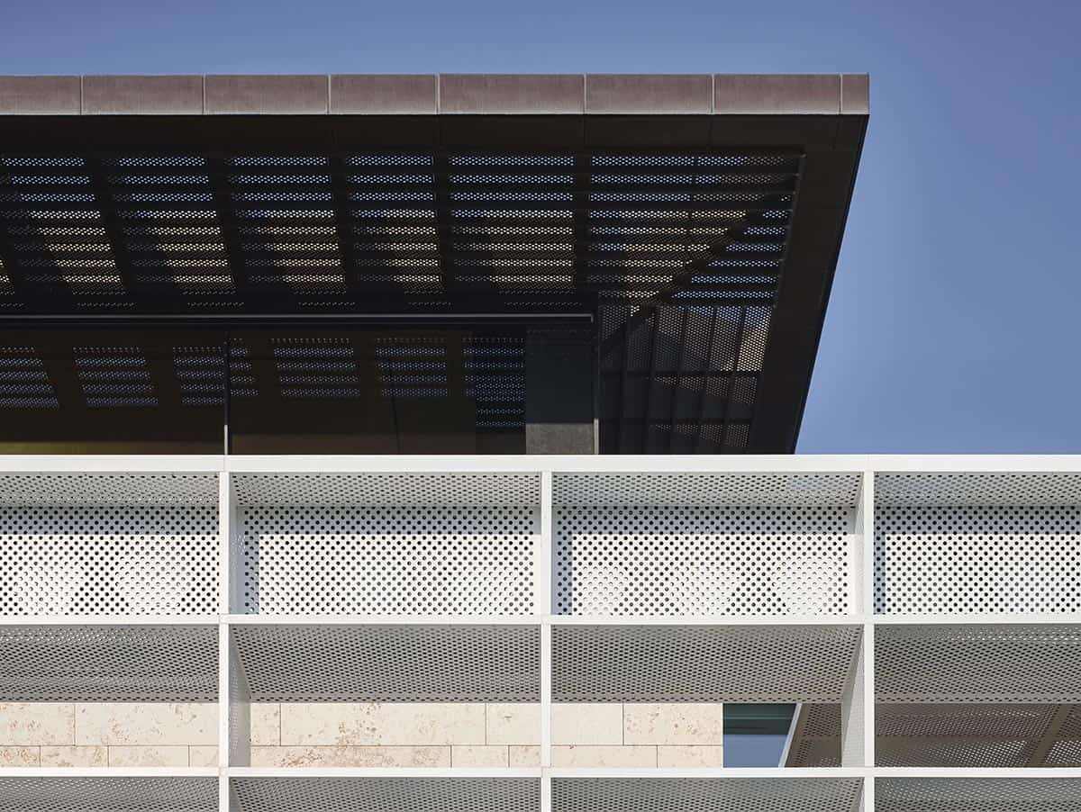 A building featuring an exterior covered in a distinctive metal mesh design