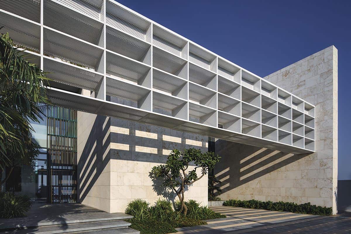 Modern building entrance featuring a large white structure, showcasing contemporary architectural design
