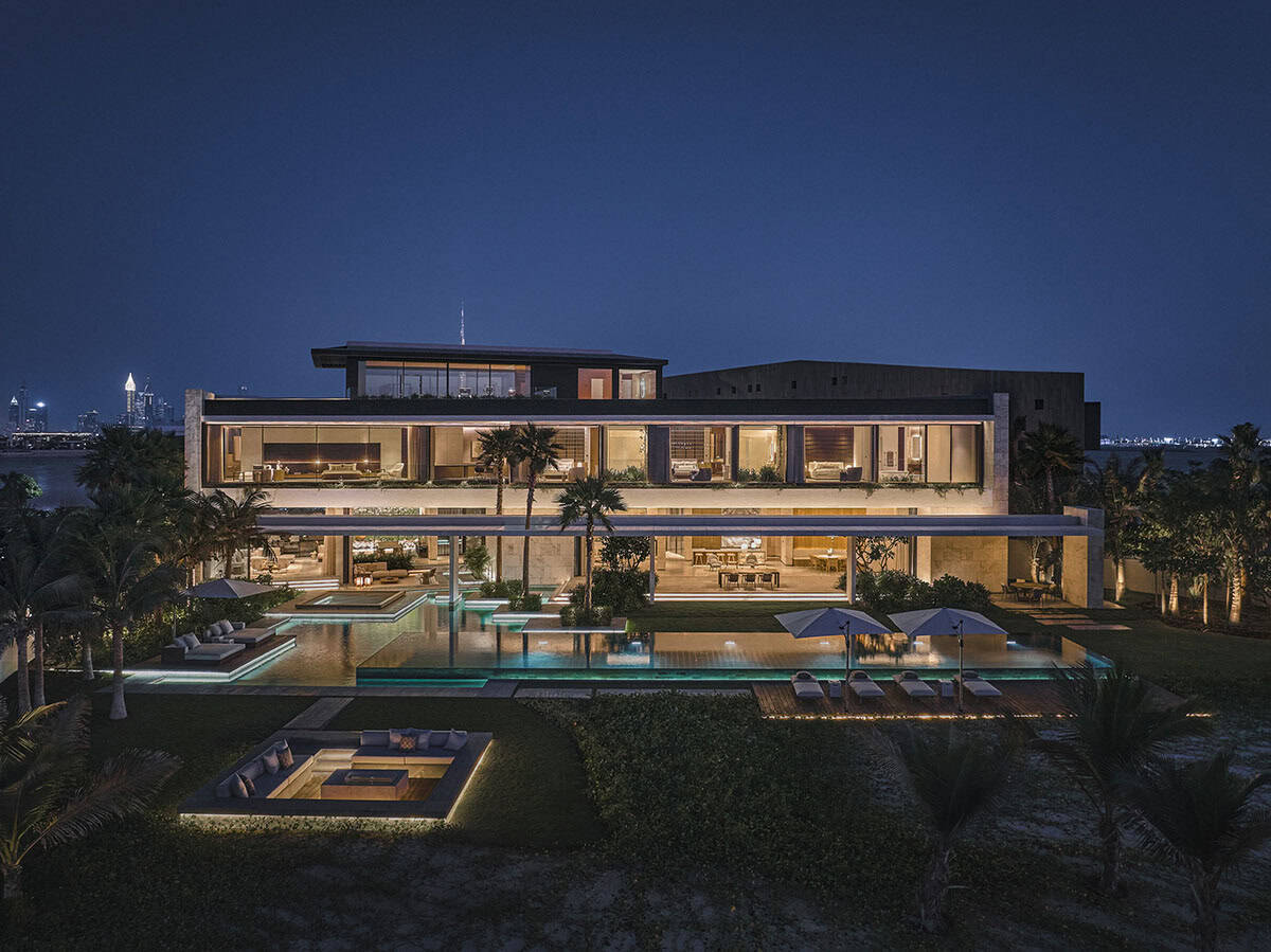 A brightly lit house at night, showcasing its warm glow against the dark sky