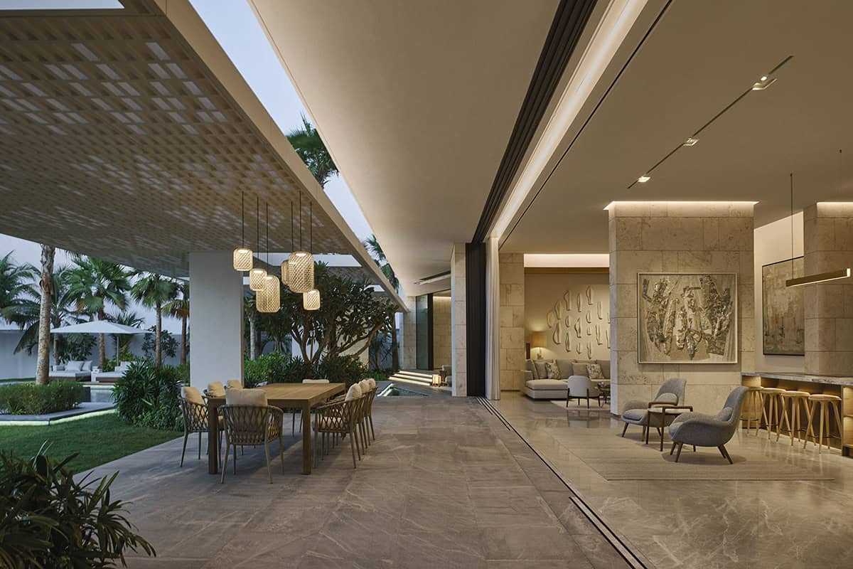 A modern home featuring sleek design elements and a view of an inviting pool through large glass doors